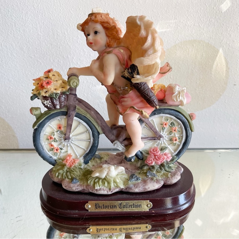 Pink Angel on Bicycle Statue Holy Figurine Religious Decoration